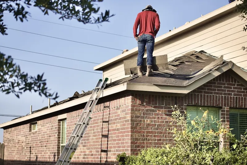 Professional roofer working on a residential roof in Ashley Acres